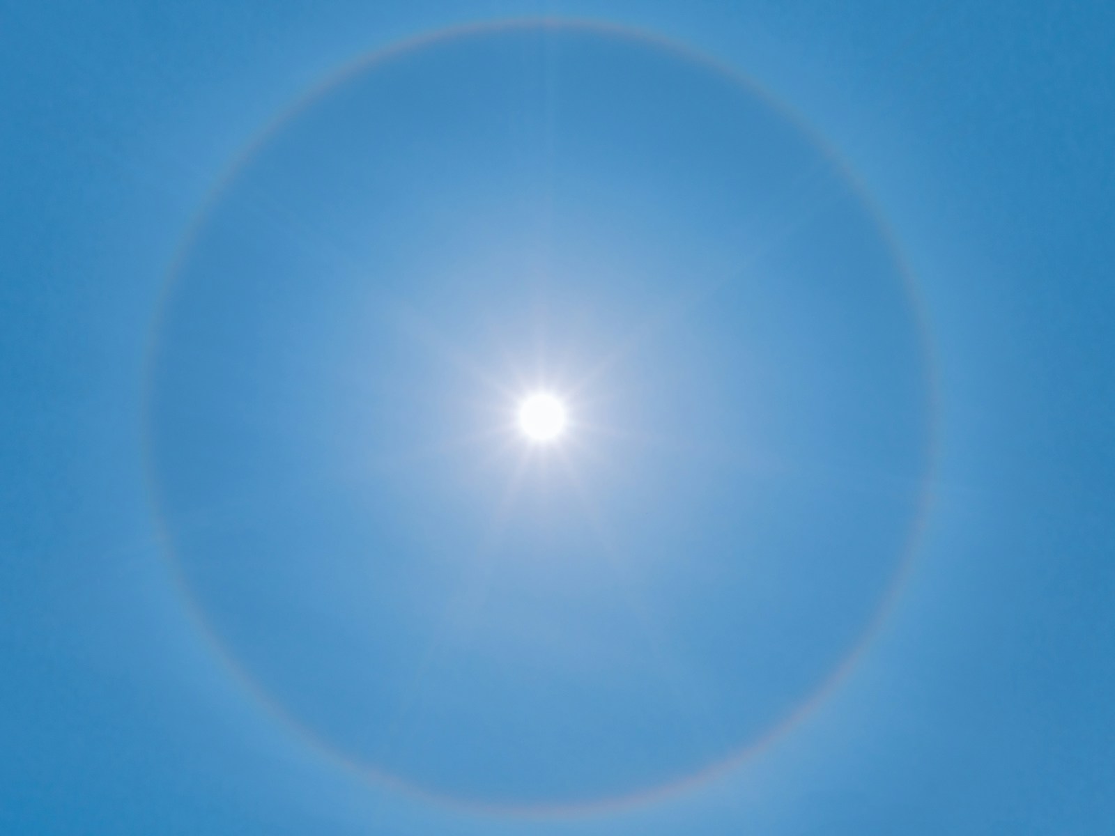 blue sky with white sun
